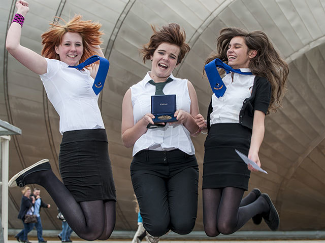 Previous winners from Alness Academy jump for joy outside the Glasgow Science Centre