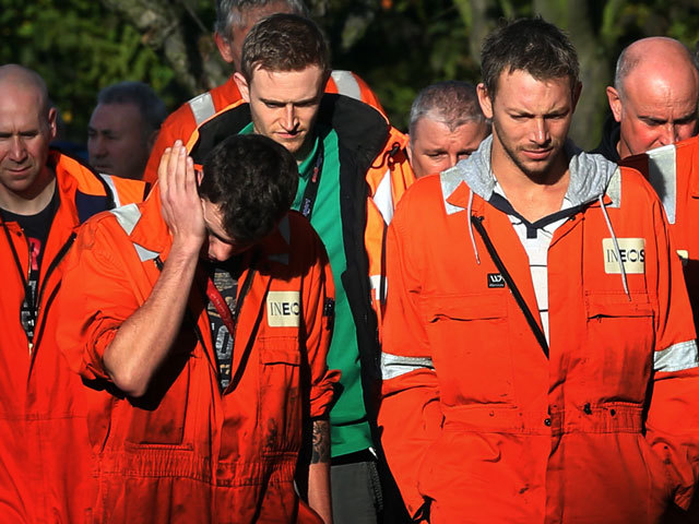 Workers walk through the Grangemouth site after being told about the closure.