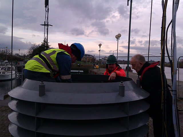 From left: David Milne of All Oceans, Brian Barnard of Current2Current and a "banksman" assistant from crane company Mammoet preparing a prototype device for trials
