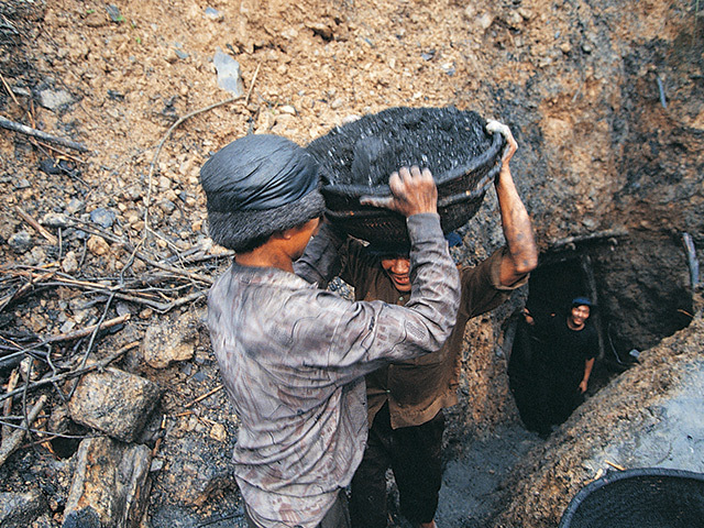 RISING CONSUMPTION: Workers in a Vietnamese coal mine