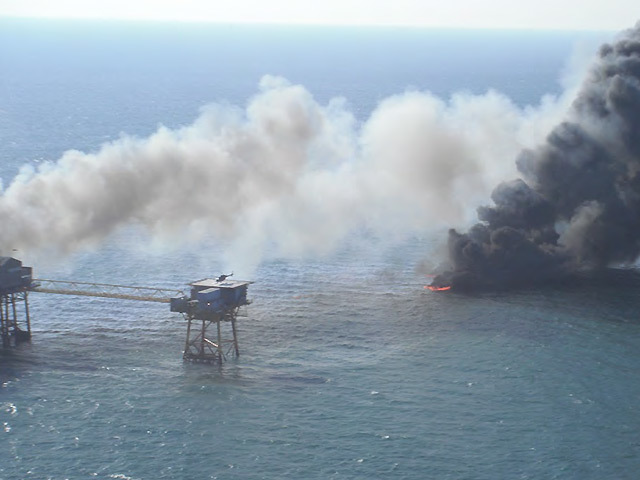 A burning oil tank in the water off the West Delta platform, blown clear of the rig by the explosion.