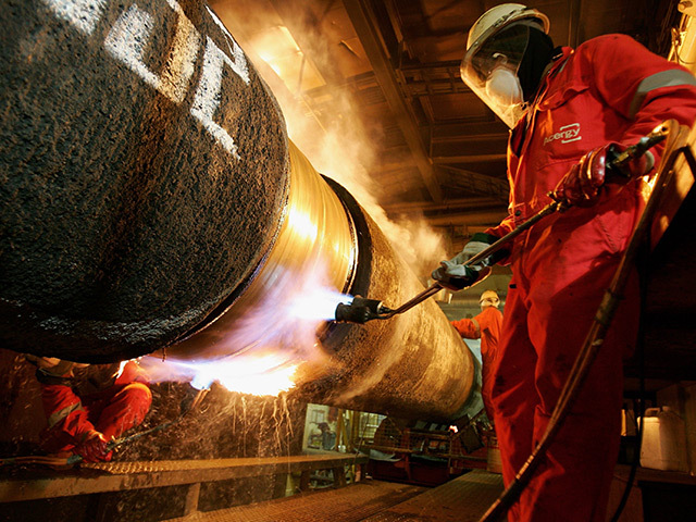 HEROIC: Workers weld two pipes together on the pipelay vessel Acergy Piper in 2006, laying what was then the world's longest trunkline between Norway and England for export of Norwegian gas supplies to the UK