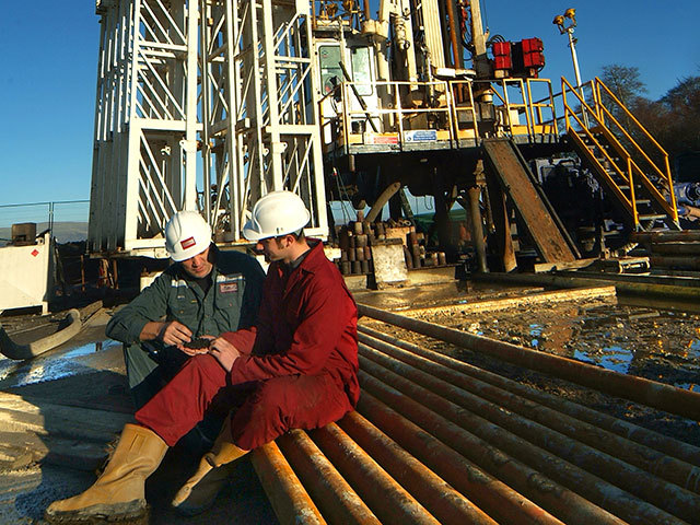 Composite Energy staff examine coals extracted from a bore hole in the central belt