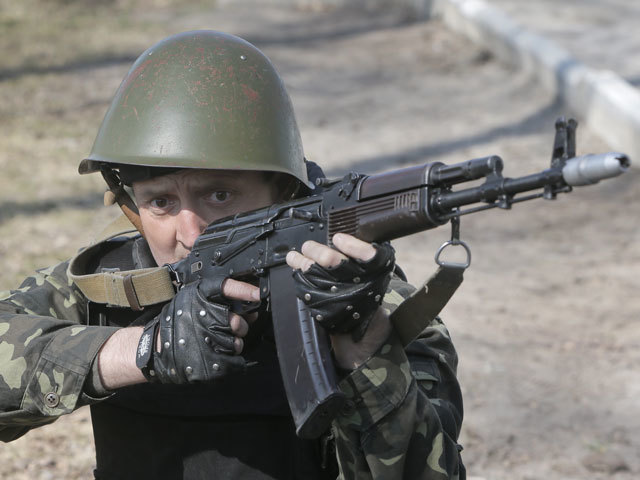 A self-defense activist performs military exercises at a military training ground outside Kiev, Ukraine