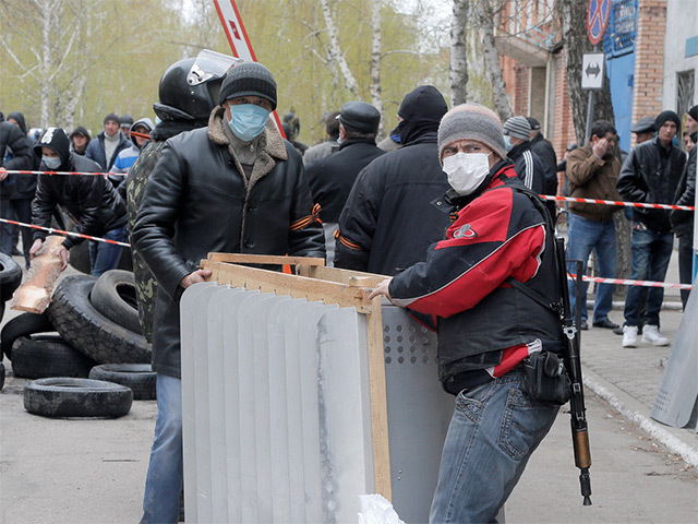 Armed pro-Russian men occupying the police station in the eastern Ukraine town of Slavyansk