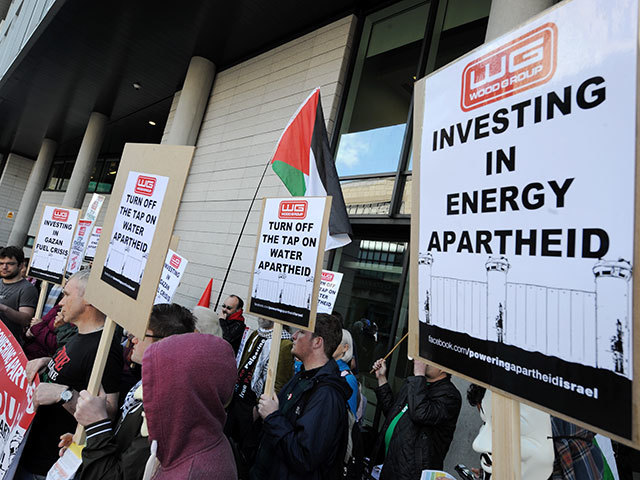 Scottish Palestine Solidarity Campaign (SPSC) protested at  Wood   Group 's AGM about the ongoing complicity in Israel's occupation and dispossession of Palestinian.