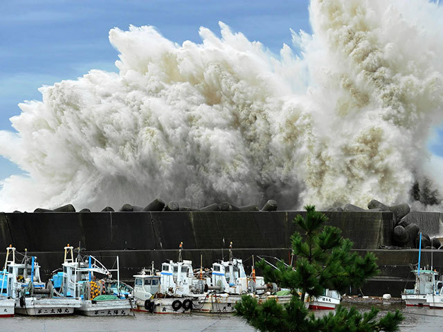 Surging waves hit against the breakwater in Udono in a port town of Kiho, Mie Prefecture, central  Japan , Wednesday, Sept. 21, 2011. A powerful  typhoon  was bearing down on  Japan 's tsunami-ravaged northeastern coast Wednesday, approaching a nuclear power plant crippled in that disaster and prompting calls for the evacuation of more than a million people.
