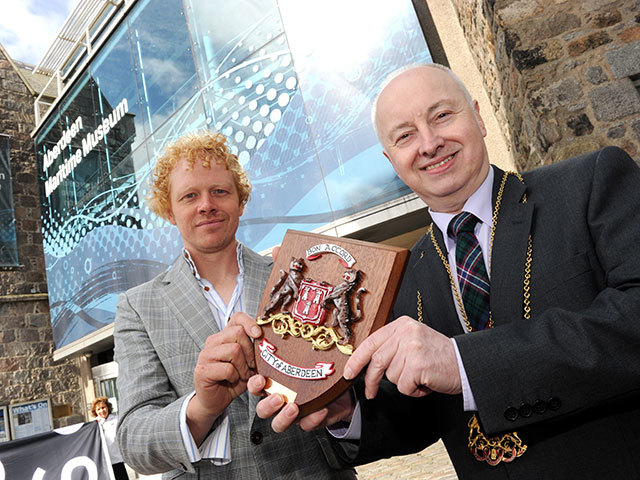 Richard Parkinson, Director of Calecore , with Lord Provost George Adam who presents him with a plaque as a gift from the people of Aberdeen to the people of Norway to mark the twin cities' historic bond.