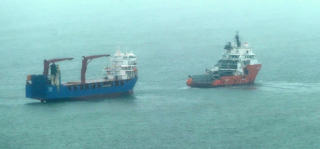 The stricken vessel  is attended by the rescue tug at the entrance to the Cromarty Firth in Easter Ross.