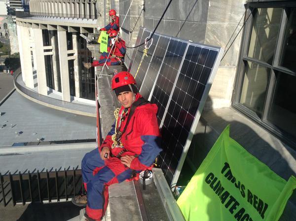 Greenpeace protesters scale parliament's roof