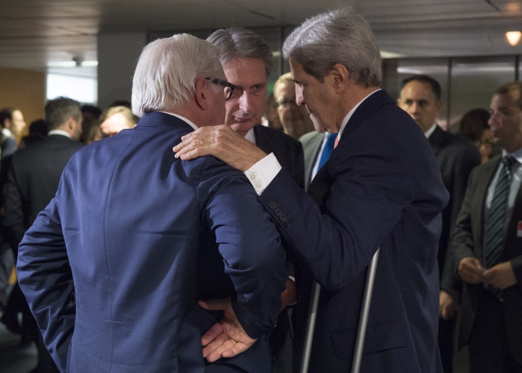German Foreign Minister Frank-Walter Steinmeier, British Secretary of State for Foreign Affairs Philip Hammond and US Secretary of State John Kerry talk prior to a plenary session at the United Nations building in Vienna, Austria
