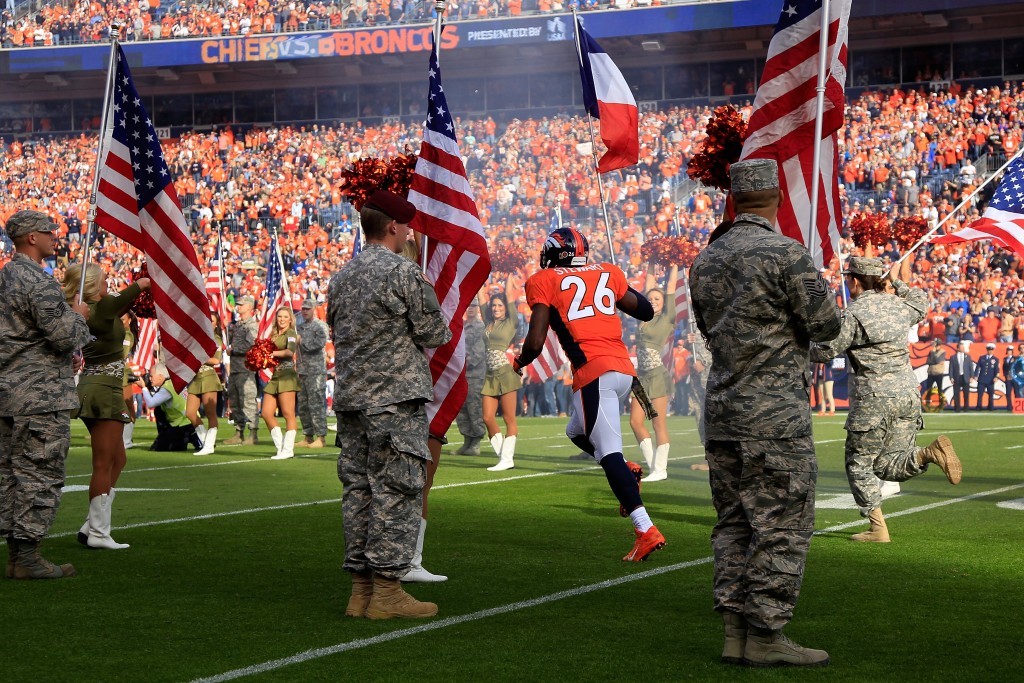 Darian Stewart #26 of the Denver Broncos carries the French flag onto the field in honor of the victims of the recent terrorist attacks in Paris prior to the game between the Kansas City Chiefs and the Denver Broncos as US Military Appreciation Day is observed at Sports Authority Field at Mile High on November 15, 2015 in Denver, Colorado