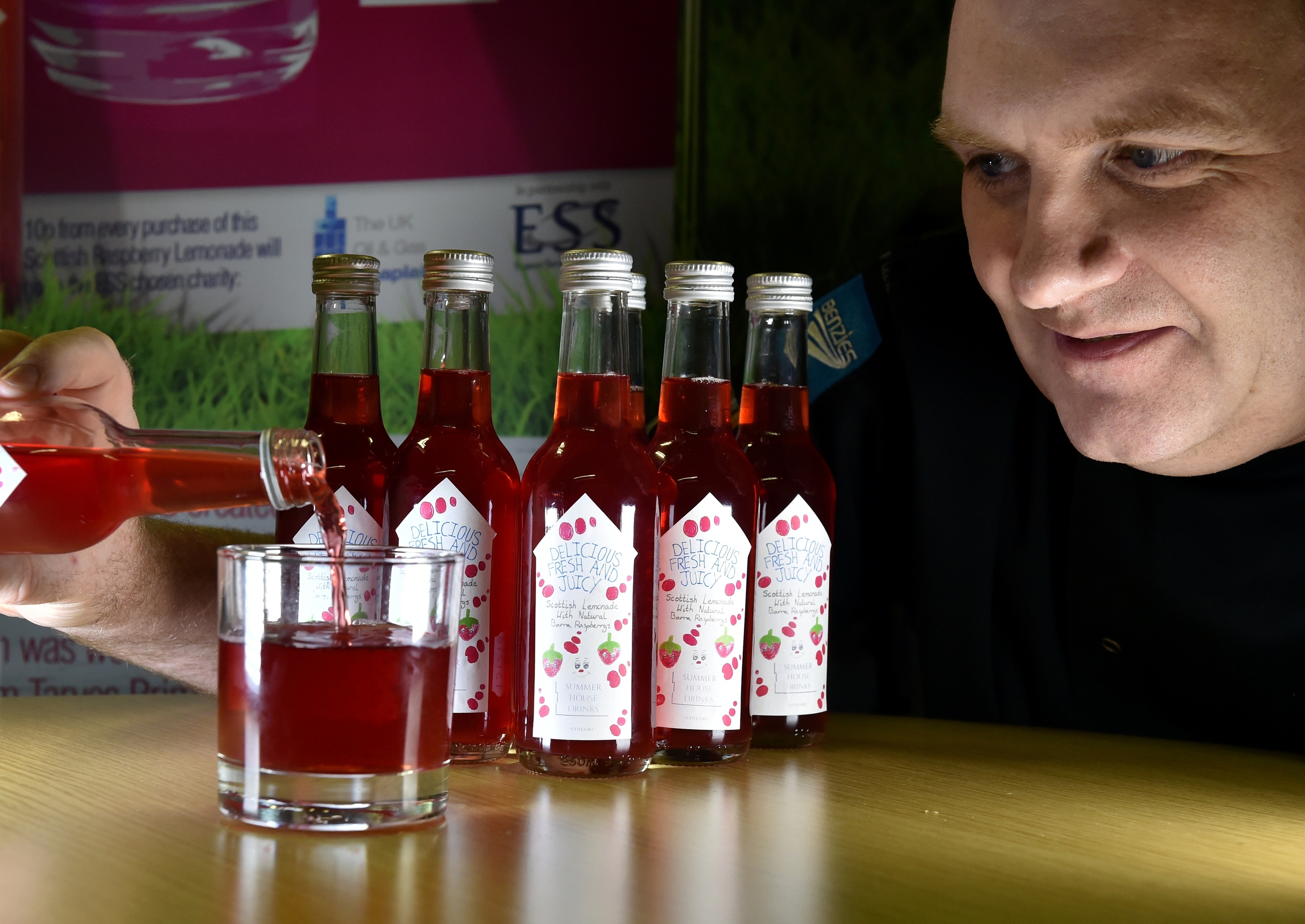 ESS in Carden Place have launched a new raspberry lemonade drink to support the Oil and Gas Chaplaincy.  Graham Singer, Food operations manager at ESS pours a drink.