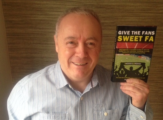 Peter Farrell holding his book, Give the Fans Sweet FA.