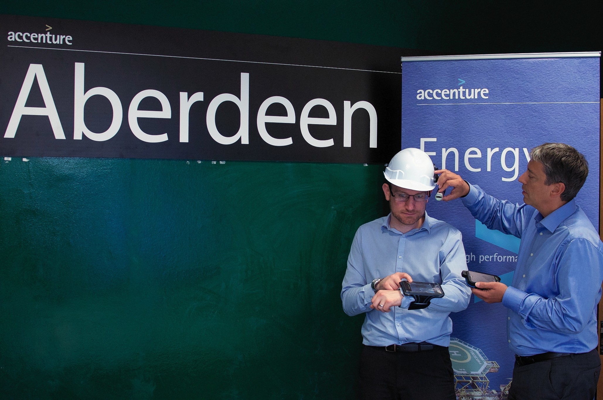 Luca Corradi, Accenture managing director in Aberdeen, right, demonstrating the company’s new wearable technology with Stuart McLeod, a manager in Accenture's Assets & Operations consulting practice.