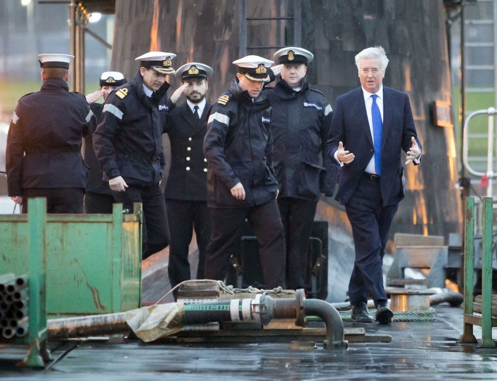 Defence Secretary Michael Fallon (right) with Daniel Martyn (front centre) Commanding Officer of HMS Vigilant and Rear Admiral of Submarines and Assistant Chief of Naval Staff John Weale (front left) during a visit to Vanguard-class submarine HMS Vigilant, one of the UK's four nuclear warhead-carrying submarines