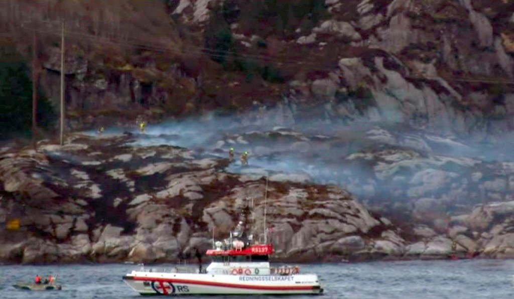 Local TV images of the crash area - A helicopter has crashed west of the Norwegian city of Bergen with 13 people on board. There were reports of people in the sea, but a rescue official told broadcaster NRK that there were no signs of any survivors. The helicopter was "totally destroyed". Photos from the scene showed thick smoke coming from an area of rocky islets. It was flying from the Gullfaks oil field to Bergen. The western city is a centre for the North Sea oil and gas industry. The helicopter, a Eurocopter 225, came down near the small island of Turoy, just west of the village of Solsvik. Picture: NRK/Universal News And Sport (Europe) 29/04/2016.