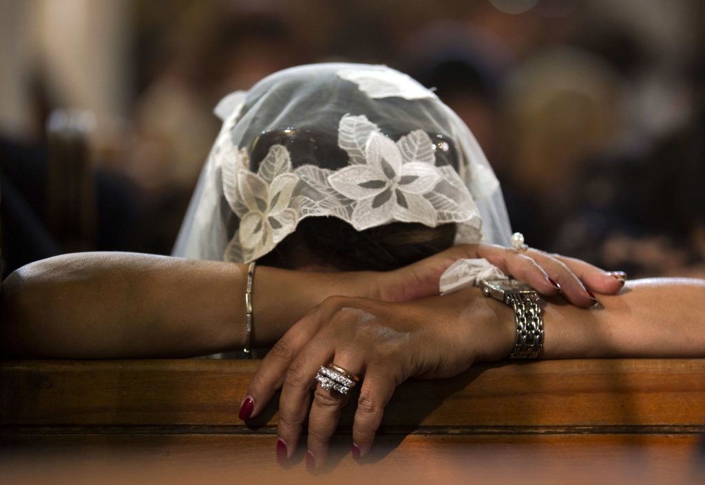A Coptic Christian grieves during prayers for the departed, remembering the victims of Thursday's crash of EgyptAir flight 804, at Al-Boutrossiya Church, the main Coptic Cathedral complex, in Cairo, Egypt, Sunday, May 22, 2016. Making his first public comments since the crash of the Airbus A320 while en route from Paris to Cairo, Egyptian President Abdel-Fattah el-Sissi said Sunday, in comments broadcast live on Egyptian TV channels, that it will take time to determine the exact cause of the crash, which killed all 66 people on board.