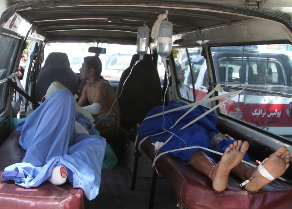 Injured Afghan men lie in an ambulance after an accident on the main highway linking the capital, Kabul, to the southern city of Kandahar, in Ghazni province eastern of Kabul, Afghanistan