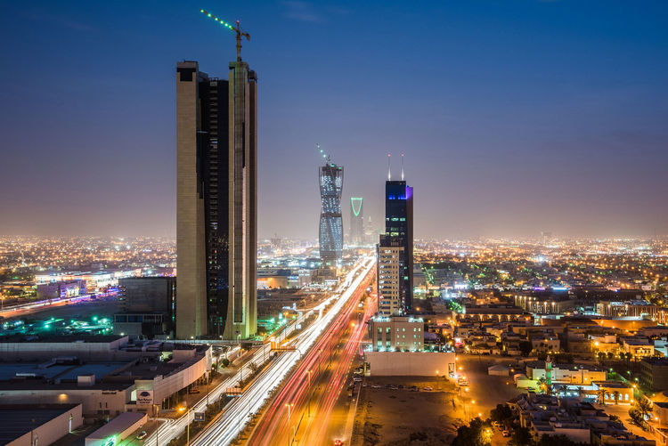 Light trails from traffic illuminate highways surrounded by residential buildings in Riyadh, Saudi Arabia