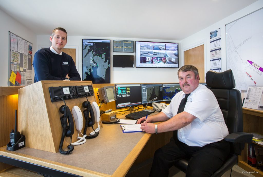 Lerwick Harbour’s port control room and the newly installed Vessel Monitoring System, with Deputy Harbourmaster Alexander Simpson (left) and Port Controller Douglas Garrick. Photo courtesy of John Coutts.