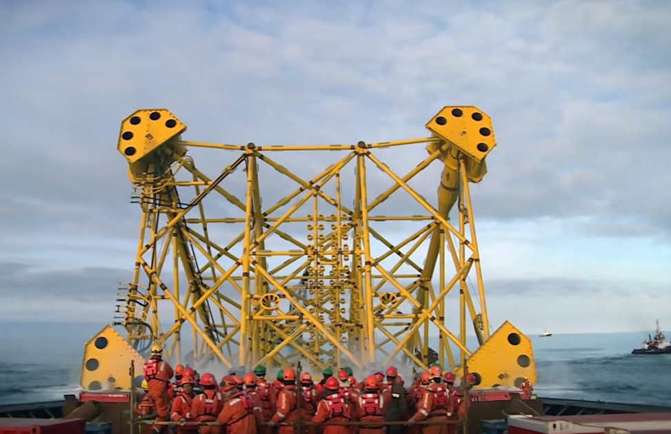 A steel support jacket being launched into the North Sea