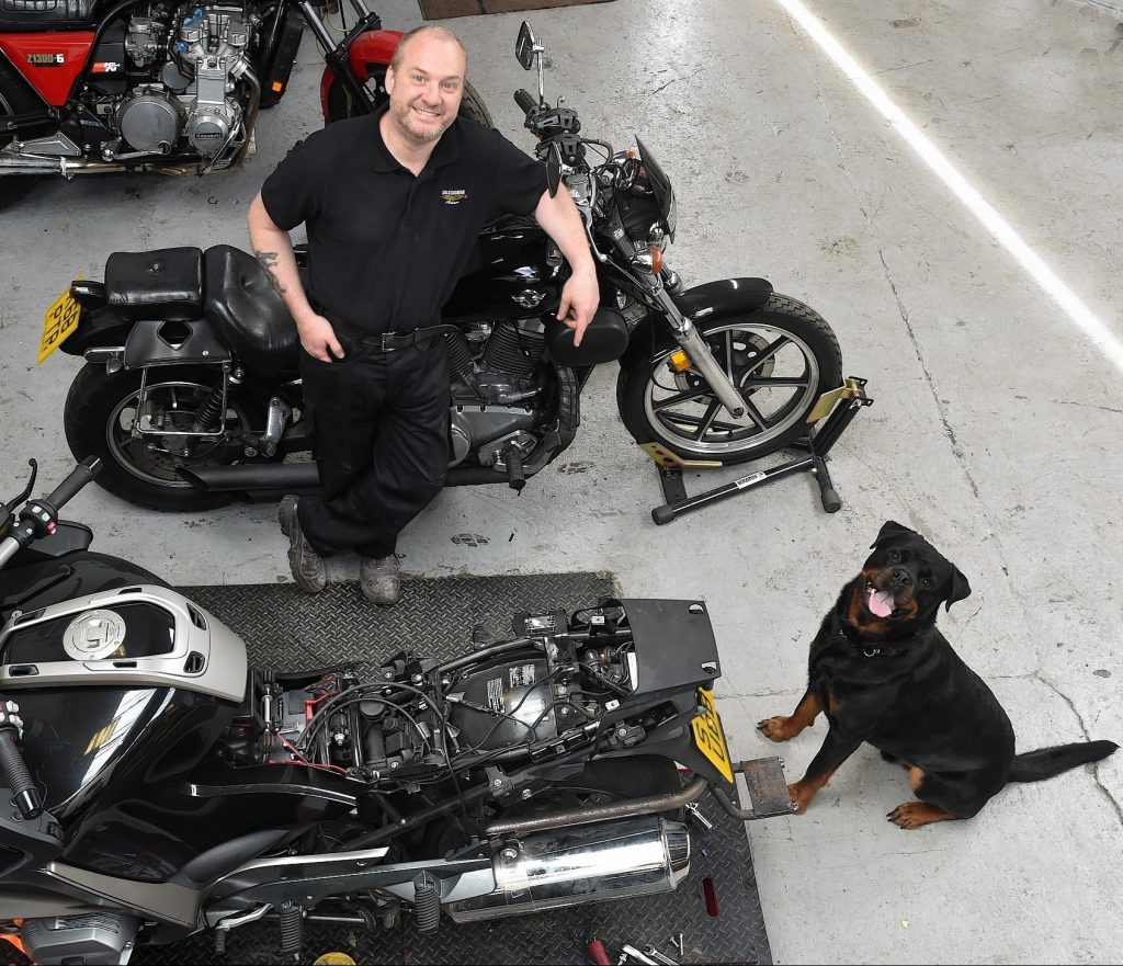 Adam Grozier pictured with his dog, Tig, at Caledonian Customs in Laurencekirk.