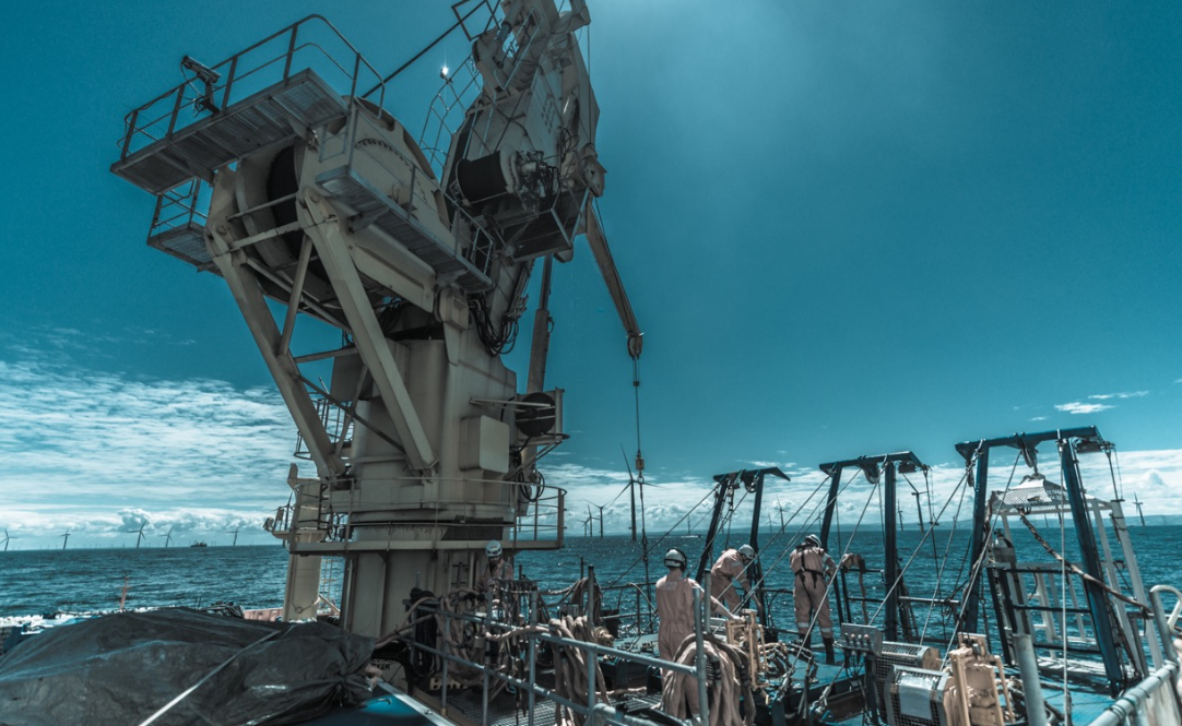 Hughes employees working on the back deck of a vessel