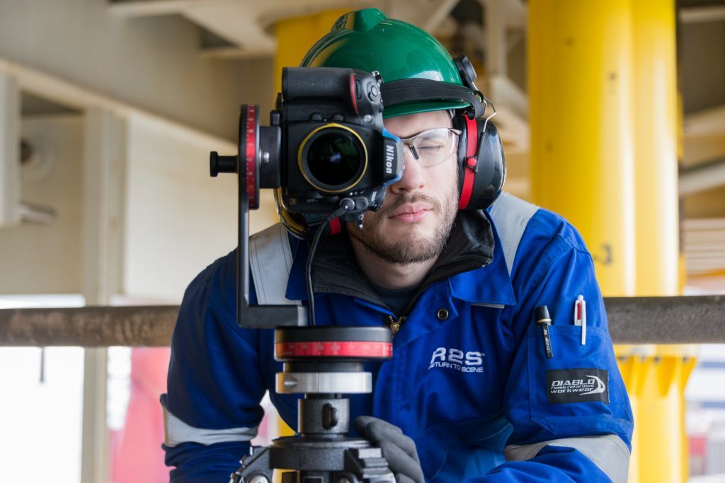 An R2S employee taking pictures for the new Mosaic system