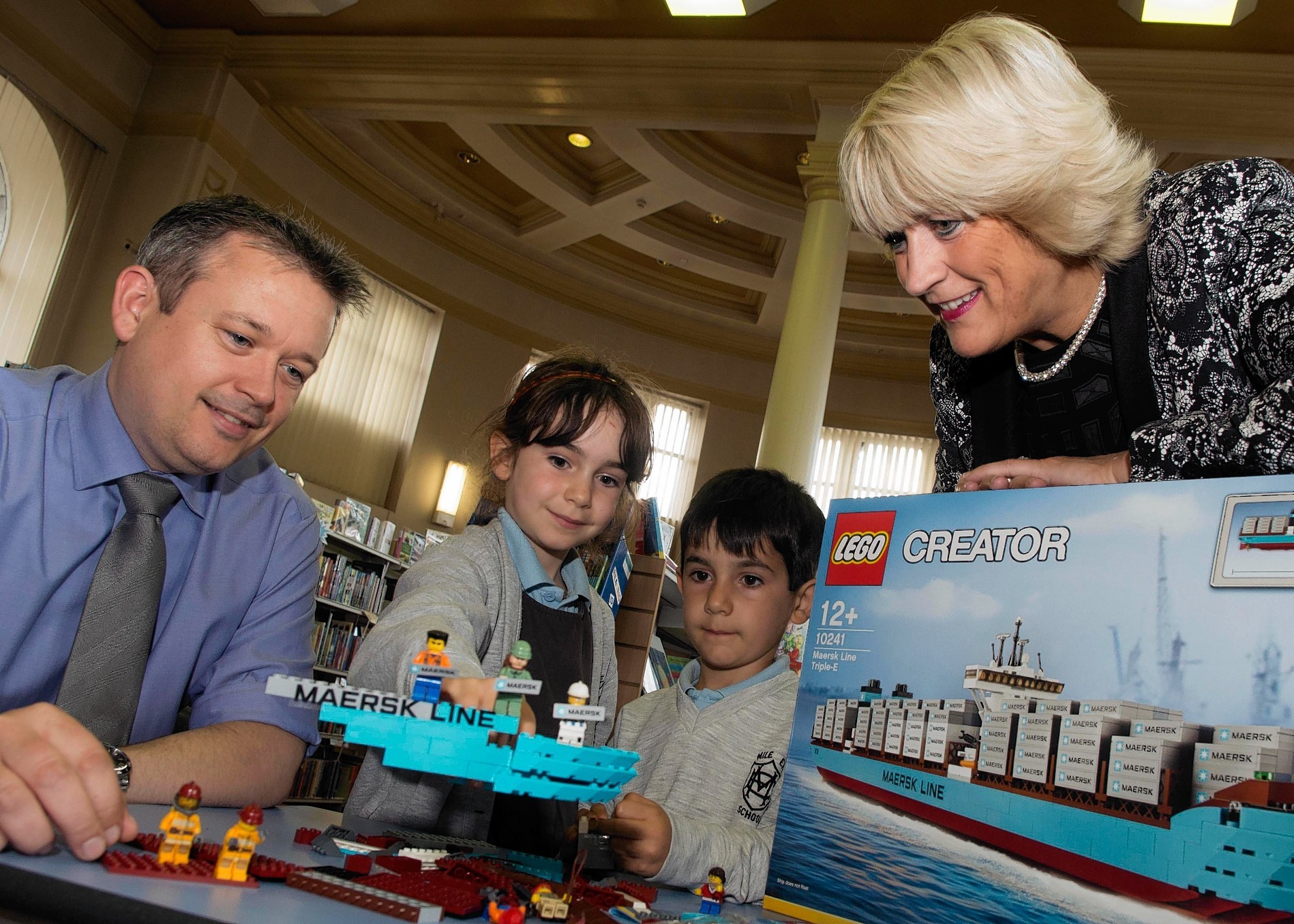 Councillor Angela taylor and Phil Masson from Maersk along with Noemi Napoletano, aged 7, and brother Alex, 6, with the new lego play kit donated by Maersk to Aberdeen City Library 
Photo by Norman Adams