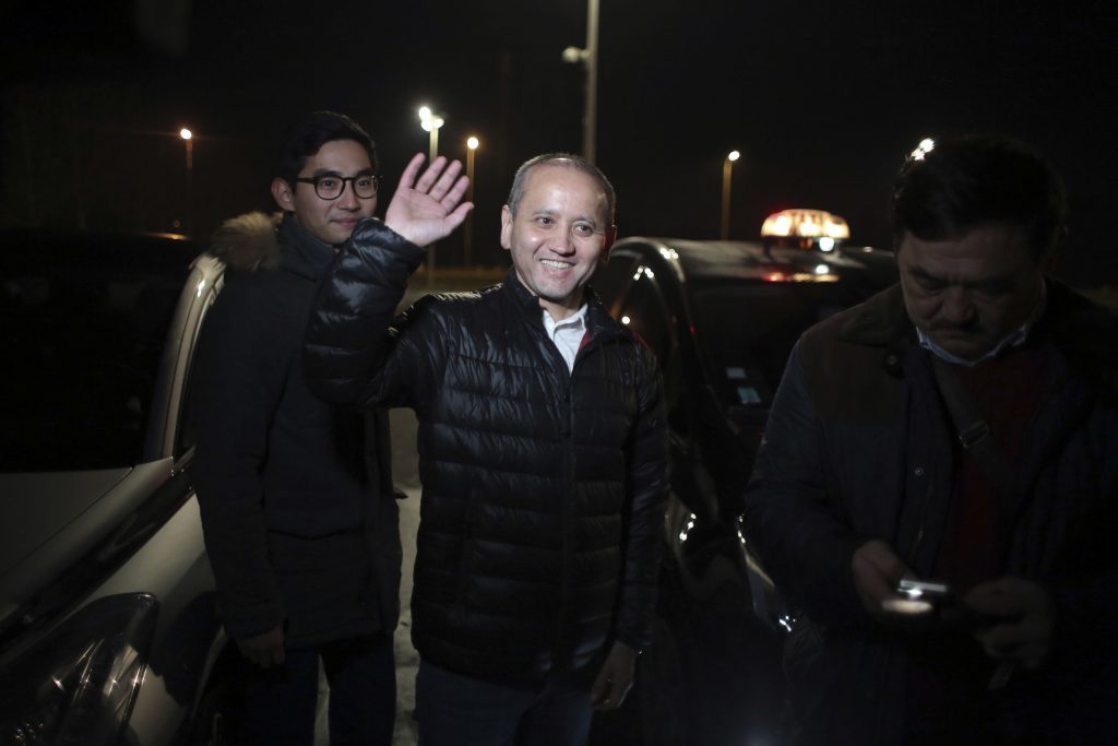 Mukhtar Ablyazov, centre, waves as he leaves the Fleury Merogis prison, in Fleury Merogis, south of Paris, Friday, Dec. 9, 2016. A top court in France refused Friday to hand the Kazakh banker-turned-dissident charged with embezzling billions over to Russia, saying it considered the extradition request from Moscow to be "politically motivated." (AP Photo/Thibault Camus)