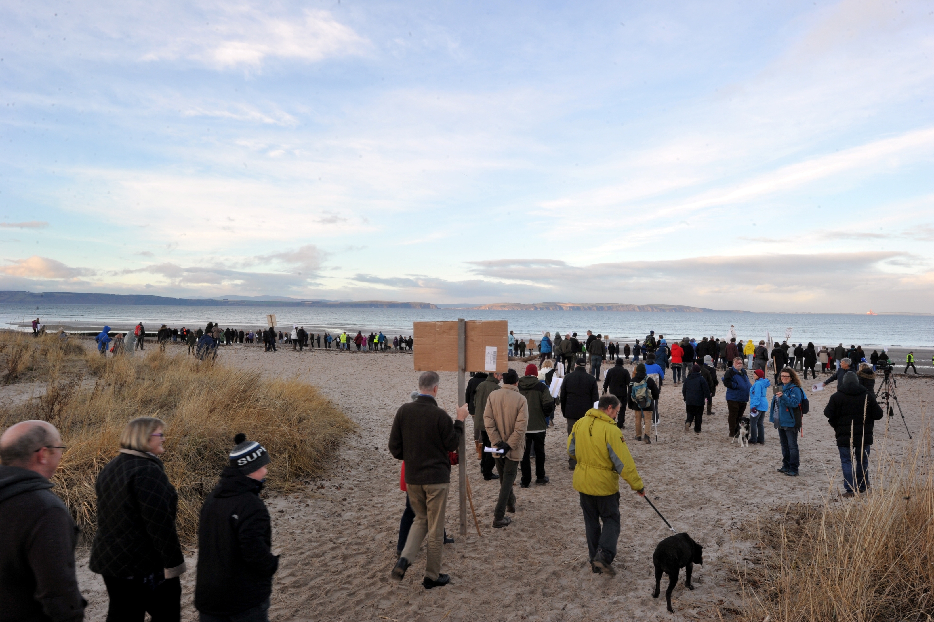 Protest at Nairn against ship to ship oil transfers in the Moray Firth.  A long line of over 500 protesters gather on the beach.