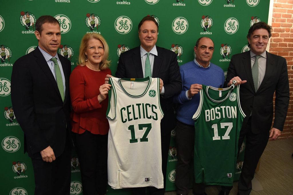 Officials from GE and the Boston Celtics unveiling the new jerseys complete with GE logos