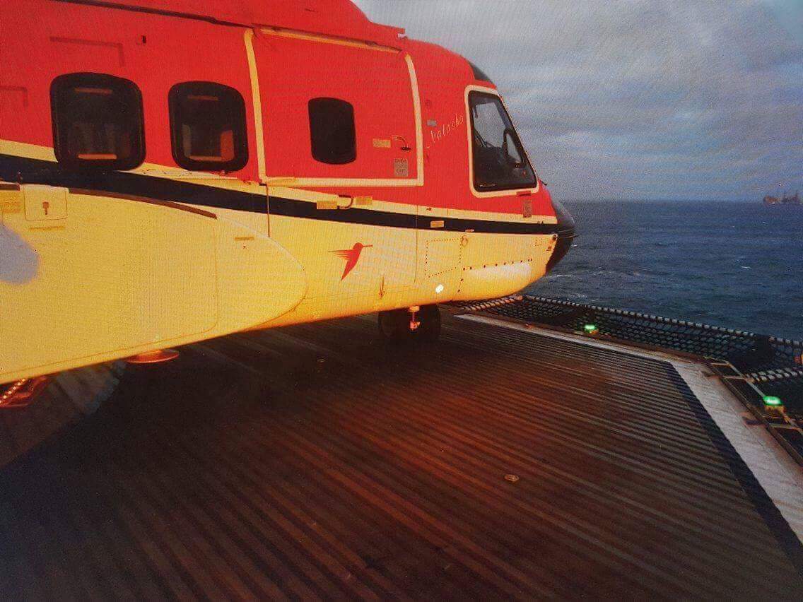 A picture showing the proximity of the helicopter's nose to the edge of the deck.