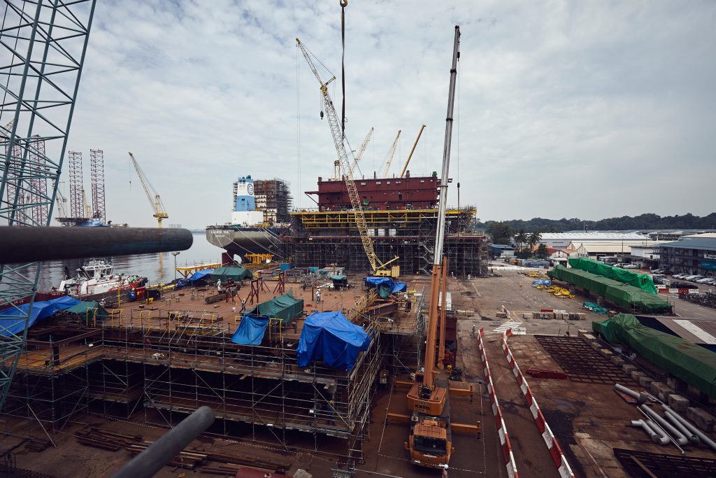 The Culzean utilities and living quarters topside, behind cranes, seen from one of the decks of the central processing facility in a yard in Singapore.