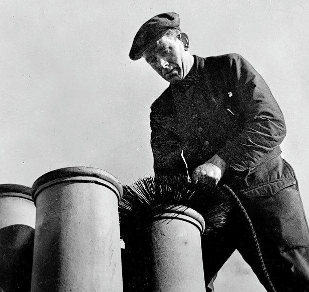 A file photo of a chimney sweep lowering a ball and brush down a chimney in Aberdeen in 1949.