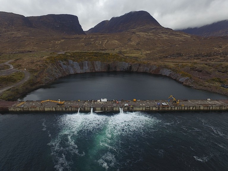 This picture of water being pumped out of the dock was issued with a teaser saying "the sleeping giant is being stirred".