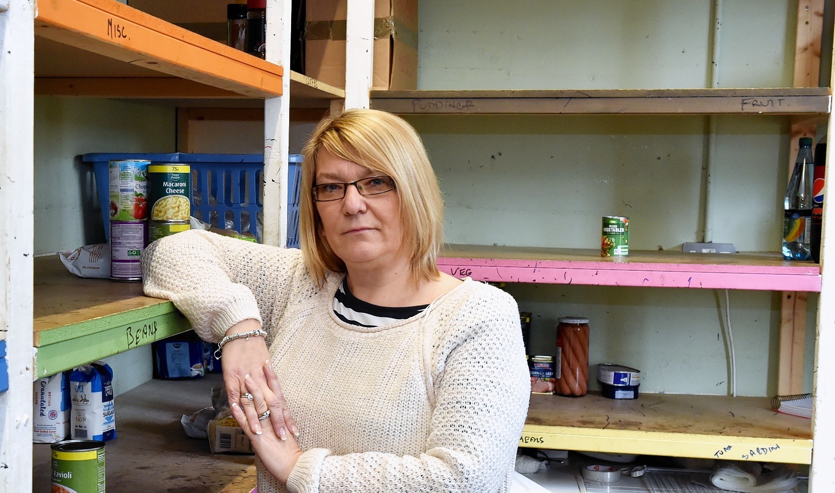 Susan Cheyne of Instant Neighbour - One third of people in the North of Scotland are missing meals to save money. Susan with the shelves at Instant Neighbour almost empty of food