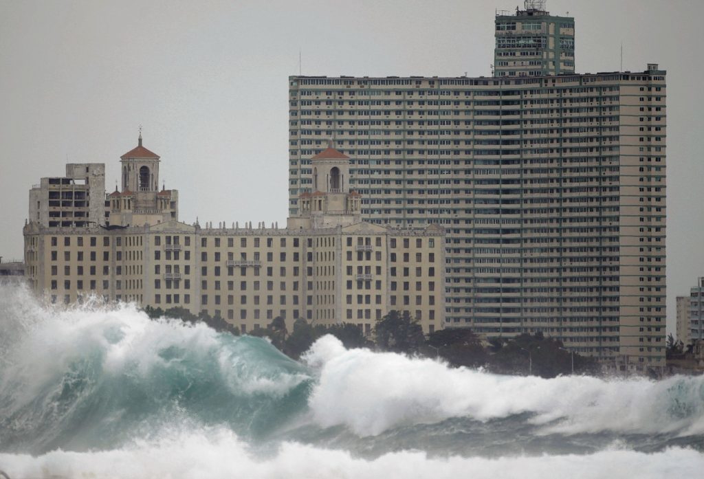 The National hotel, left, and Riviera hotel stand behind waves hitting Havana's Malecon seafront in Cuba, Monday Dec. 13, 2010.