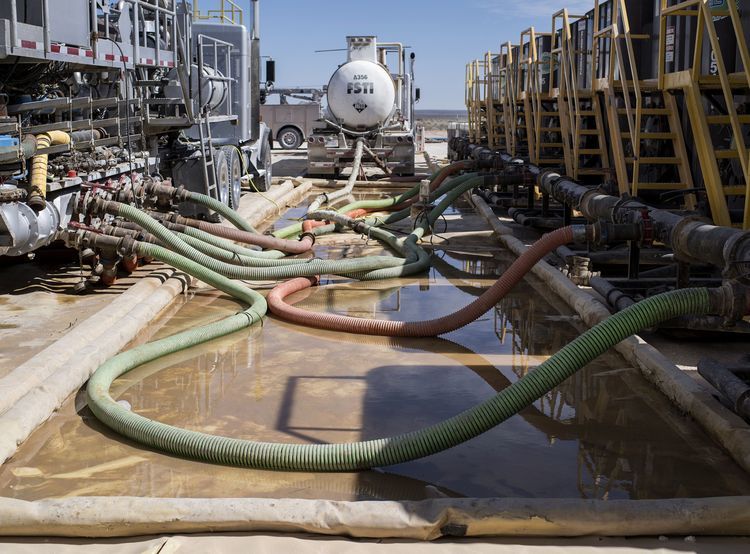 Hoses carry water to hydraulic fracking machinery at a Royal Dutch Shell Plc site near Mentone, Texas, U.S., on Thursday, March 2, 2017. Exxon Mobil Corp., Royal Dutch Shell and Chevron Corp., are jumping into American shale with gusto, planning to spend a combined $10 billion this year, up from next to nothing only a few years ago. Photographer: Matthew Busch/Bloomberg