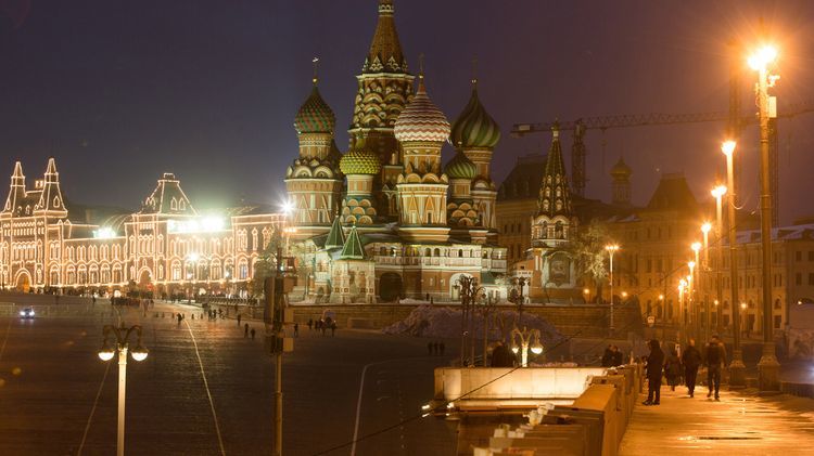 The GUM luxury department store, left, sits illuminated at night on Red Square near St. Basil's cathedral in Moscow, Russia, on Wednesday, Nov. 9, 2016. Russia is realistic about limits on the prospects for an immediate improvement in relations with the U.S. after President-elect Donald Trump takes office, according to President Vladimir Putins spokesman. Photographer: Andrey Rudakov/Bloomberg