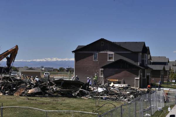 Workers in Firestone, Colo., dismantle the charred remains of a house where a petroleum industry gas line leak explosion killed two people.