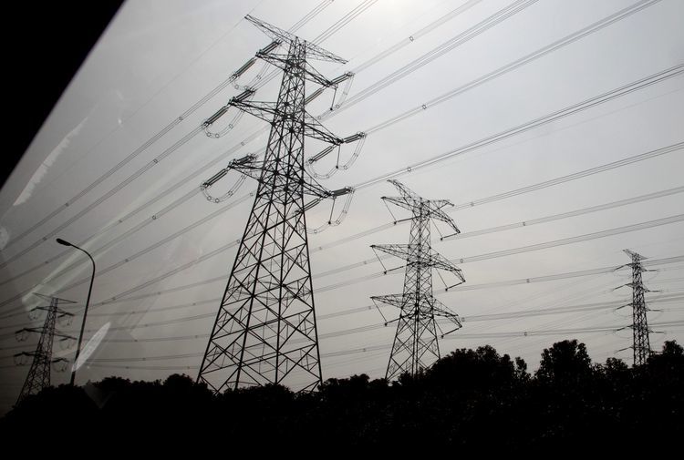 Electricity pylons are seen from a car window near the Yangshan Deep Water Port in Shanghai, China.