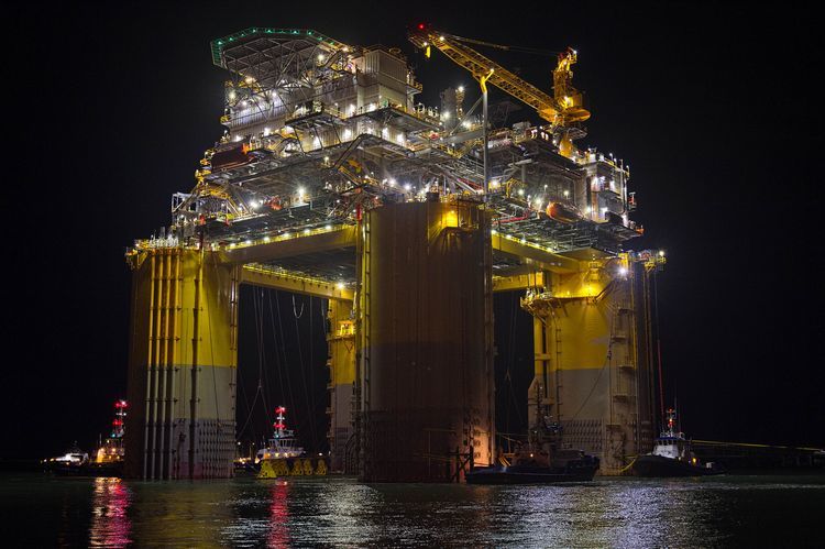 Tug boats transport the Hess Corp. Stampede tension leg oil platform, towed from Kiewit Offshore Services Ltd., past Port Aransas, Texas, U.S., on Friday, May 5, 2017.