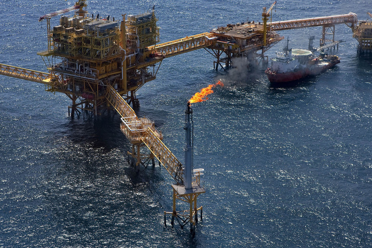 Gas is flared off from a Petroleos Mexicanos offshore platform producing oil from the Ku-Maloob-Zaap field in the Gulf of Mexico 65 miles northeast of Ciudad del Carmen, Mexico, on Thursday, Oct. 7, 2010. Photographer: Susana Gonzalez/Bloomberg