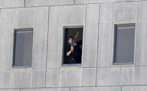 An armed man stands in a window of the parliament building in Tehran, Iran, Wednesday, June 7, 2017. Several attackers stormed into Iran's parliament and a suicide bomber targeted the shrine of Ayatollah Ruhollah Khomeini on Wednesday, killing a security guard and wounding several other people in rare twin attacks, with the shooting at the legislature still underway. (Fars News Agency, Omid Vahabzadeh via AP)