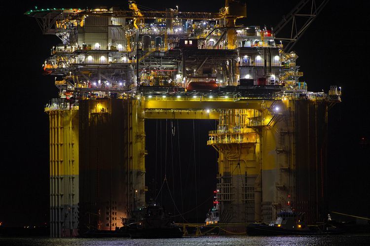 Tug boats transport the Hess Corp. Stampede tension leg oil platform, towed from Kiewit Offshore Services Ltd., past Port Aransas, Texas, U.S. Photographer: Eddie Seal/Bloomberg via Getty Images