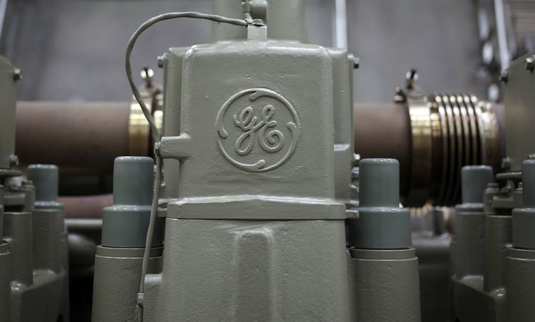 A General Electric Co. (GE) logo is seen on a twelve cylinder diesel engine for an Evolution Series Tier 4 diesel locomotive at the GE Manufacturing Solutions facility in Fort Worth, Texas, U.S. Photographer: Luke Sharrett/Bloomberg