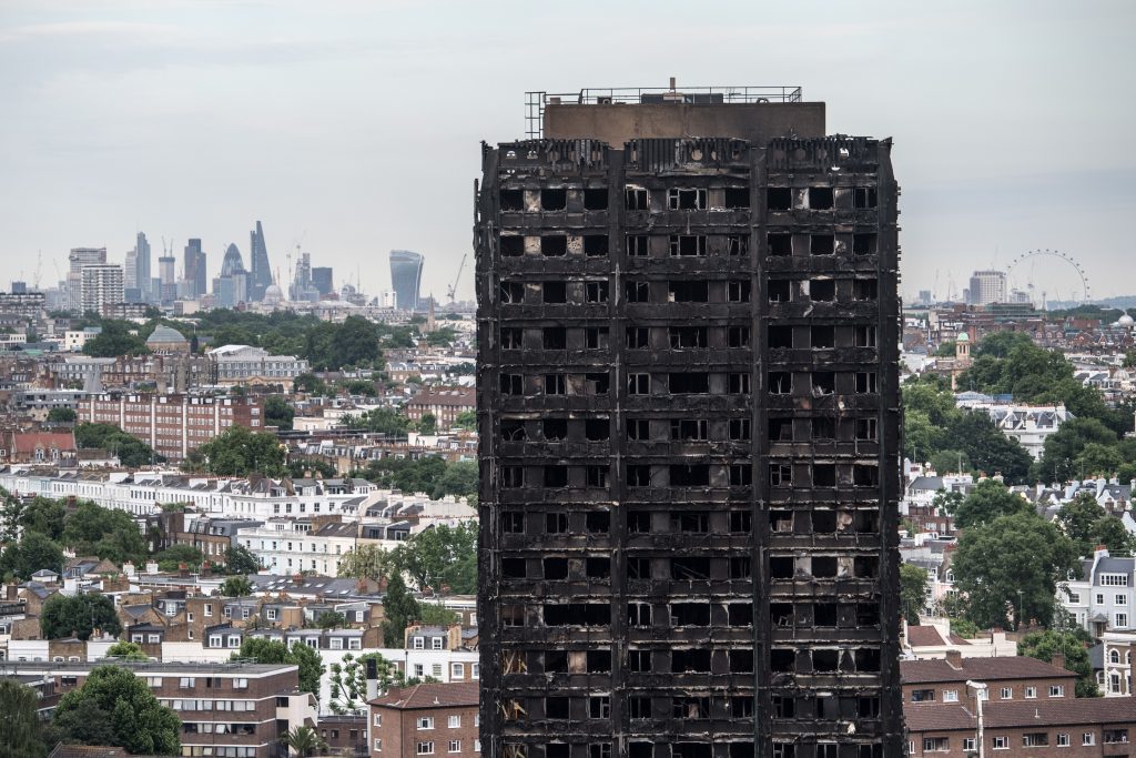 The City of London skyline is seen behind the remains of Grenfell Tower on June 26, 2017 in London, England. 79 people have been confirmed dead and dozens still missing after the 24 storey residential Grenfell Tower block was engulfed in flames in the early hours of June 14, 2017.