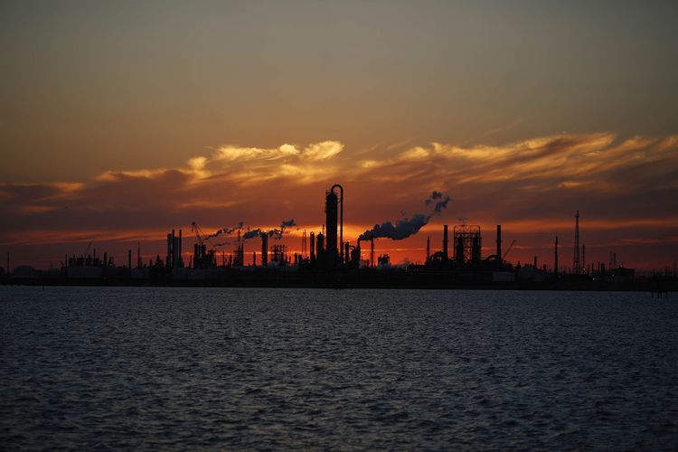 Emissions rise from an oil refinery at sunset in Texas City, Texas, U.S., on Thursday, Feb. 16, 2017. Asia's energy importers will benefit from more opportunities for arbitrage, supply diversification if U.S. President Donald Trump's pro-energy policies drive meaningful upsurge in U.S. crude, LNG exports, BMI Research reports.